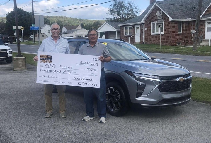 Joe Lacue presenting a large Check to the Local AYSO soccer team at Lacue Chevrolet in Patton PA